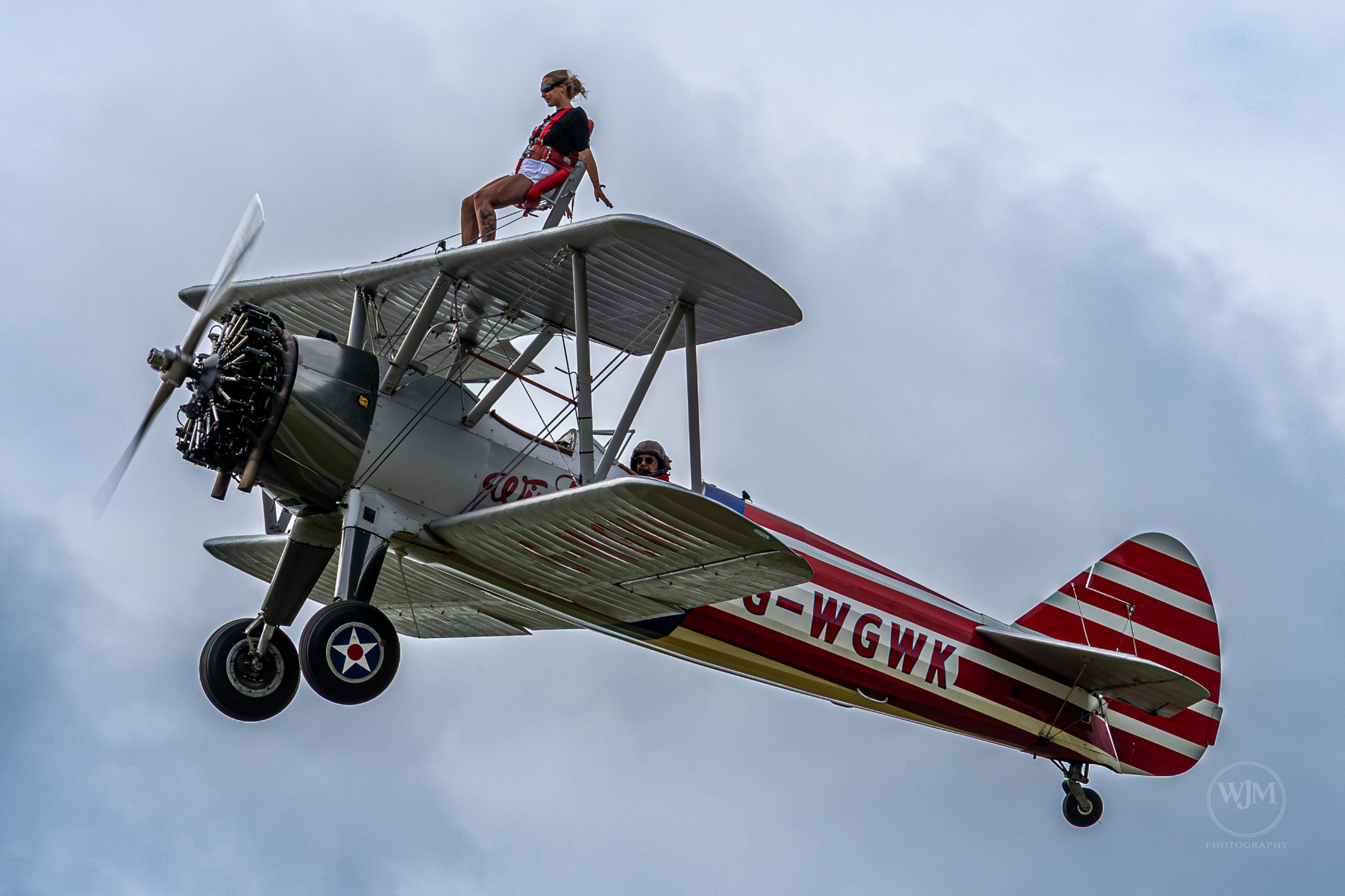 Close pass of Boeing Stearman with wing walker