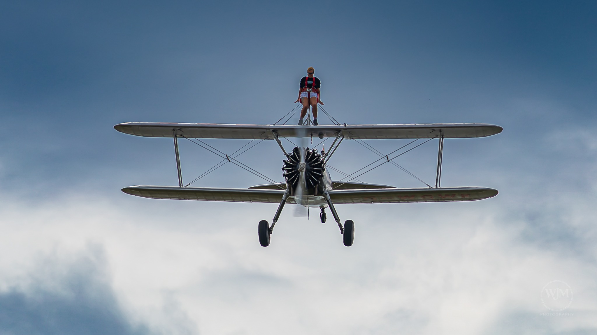 Head-on view of Boeing Stearman with wing walker